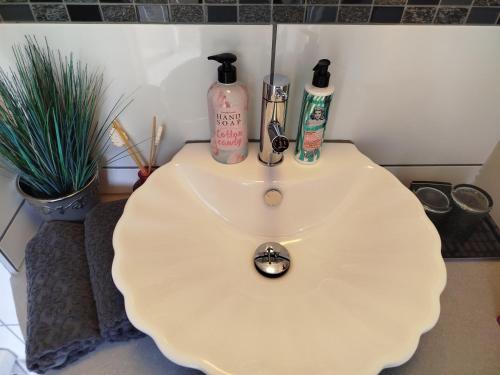 a bathroom sink with two bottles on top of it at Apartment Lena 
