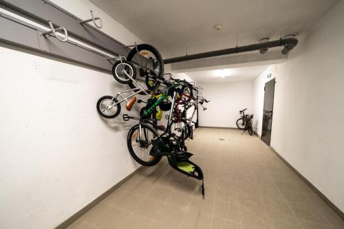a room with two bikes hanging on a wall at Appartement Neuf au pied Prorel in Briançon