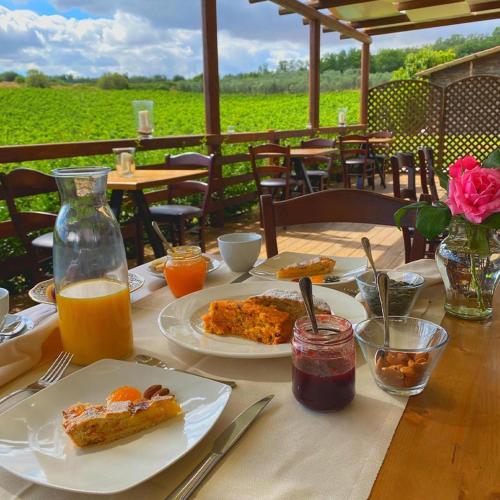 a table with plates of food and drinks on it at Agriturismo Tenuta Lagala in Venosa