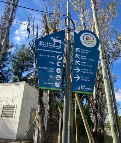 a blue sign on a pole with trees in the background at Modern apartment in San Fernando in San Fernando