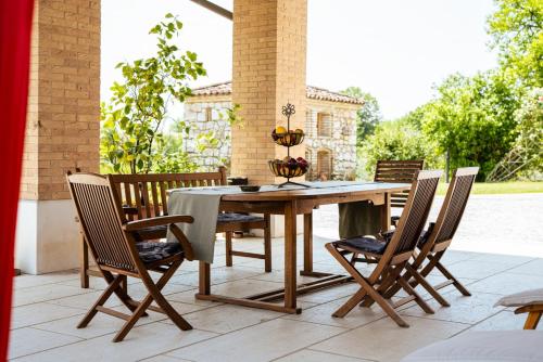 a wooden table and chairs on a patio at Country House Due Fiumi in Sacile