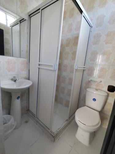 a bathroom with a shower and a toilet and a sink at Hotel Madeleine Inn Sede Sur in Barranquilla