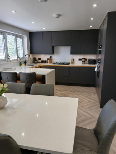 a kitchen with a white table and chairs at Newly renovated house Elgin in Elgin
