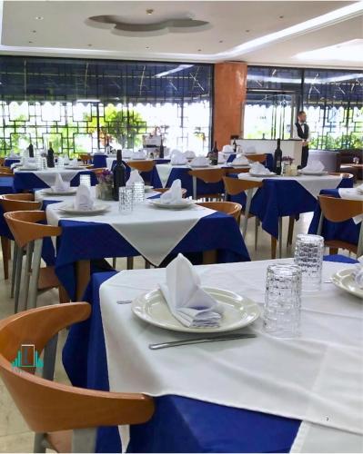 a dining room with blue and white tables and chairs at Hotel Emperador in Valencia