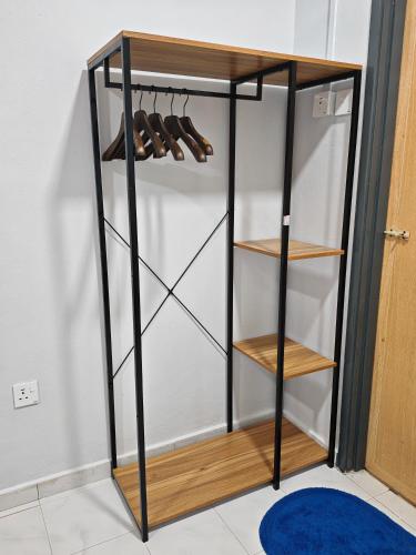 a black closet with wooden shelves and shoes at MixxHome Seremban 2, One Queen Bed, Private Bathroom in Seremban