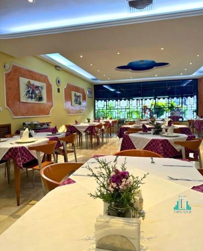 a restaurant with tables and chairs and a blue fish on the ceiling at Hotel Emperador in Valencia
