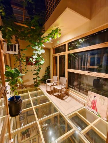 a room with a table and chairs and a glass floor at Devi music ashram in Rishīkesh