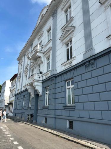 a blue and white building on the side of a street at Apartman Hasičská in Trenčín