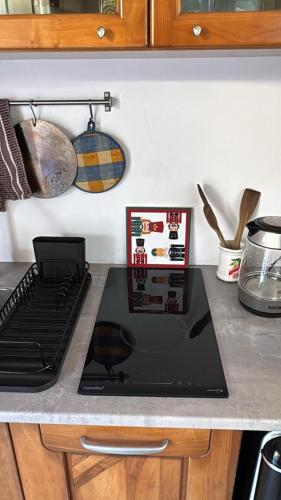 a laptop computer sitting on top of a kitchen counter at Villa Ninfa Luxe in Arona