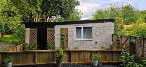 a tiny house with a wooden fence at furnace halls in Taffs Well