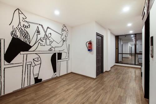 a room with a drawing on the wall at Hotel O Noida premium inn in Noida