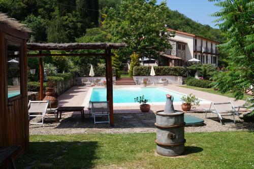 a swimming pool with a gazebo next to a house at Il Borghetto di Carra in Talla