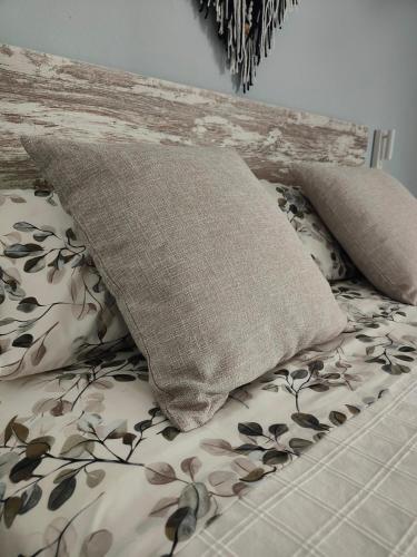 a pillow sitting on top of a bed at Can Costals Olivo in Pals