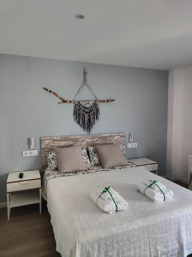 a bedroom with a bed with two pillows on it at Can Costals Olivo in Pals
