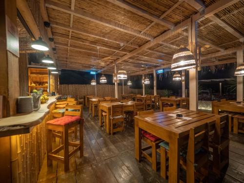 a dining room with wooden tables and chairs at Trsteno Beach Apartments in Budva