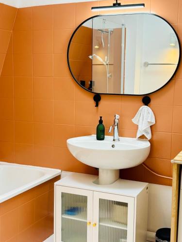 a bathroom with a sink and a mirror at La Cour Dudon - Amazing & central appartment in Bordeaux in Bordeaux