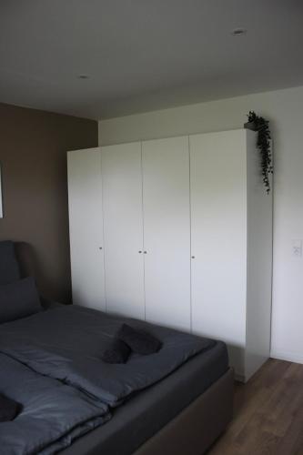 a bedroom with a bed and white cabinets at Quartier 70 Bremerhaven in Bremerhaven