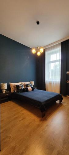 a bedroom with a large bed in a room at Apartament Magnolia in Nysa