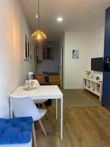 a living room with a white table and a couch at Blue Essence Apartment - Central in Coimbra