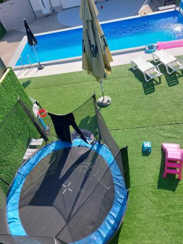 an umbrella next to a swimming pool with a tent at AQUA VET Velika Kladuša in Velika Kladuša