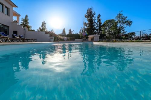 a swimming pool in a house with blue water at Villa Natura in Kalamos