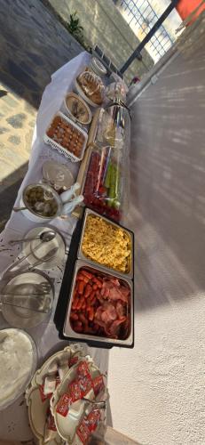 a table with several trays of food on it at GLIPTIS Apartments in Karfas