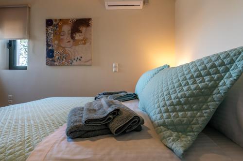 a bedroom with a bed with a blanket and a pillow at Villa Natura in Kalamos