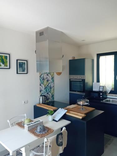 a kitchen with blue cabinets and a counter top at Ama(A’ in Fano