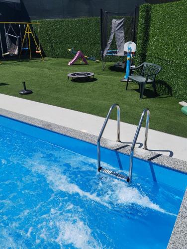 a swimming pool with a play area and a playground at AQUA VET Velika Kladuša in Velika Kladuša