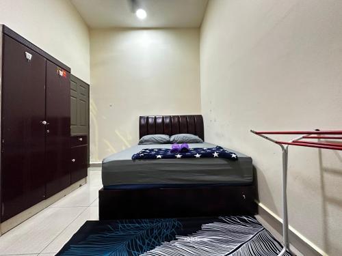 a small bedroom with a bed in a room at Homestay Ummi Gong Badak 2 in Kuala Terengganu
