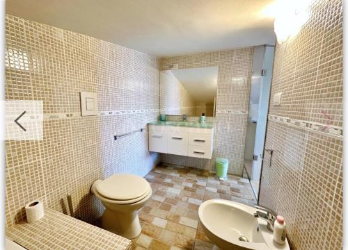 a bathroom with a toilet and a sink at Suite Tania in Fregene