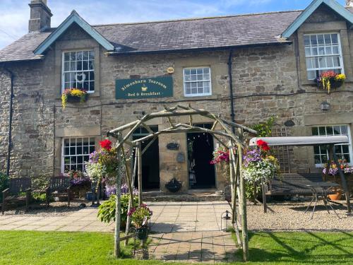 an arch in front of a stone building at Simonburn Bed and Breakfast 