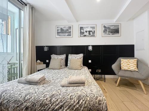 a bedroom with a large bed and a chair at Lou Pitchoun in Aix-en-Provence