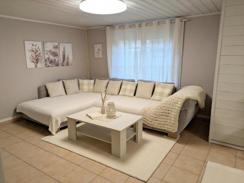 a living room with a couch and a table at Ferienwohnung Blütenzauber in Idyllischer Lage Nähe Bodensee in Hilzingen
