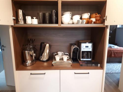 a kitchen with a cupboard filled with utensils at Schafberg Luxury Apartment in St. Wolfgang