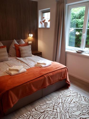 a bedroom with a bed with two towels on it at Schafberg Luxury Apartment in St. Wolfgang