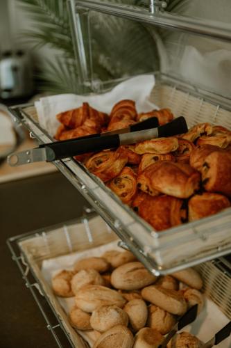a bunch of breads and pastries in trays at Hotel Jachtlust in Borne