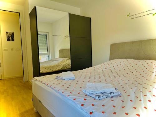 sypialnia z łóżkiem i dużym lustrem w obiekcie Apartment Clover Sarajevo w Sarajewie