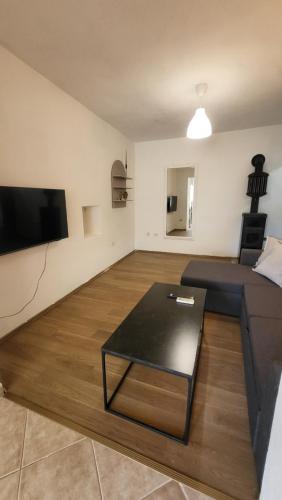 a living room with a couch and a coffee table at Apartman Sirius in Skradin
