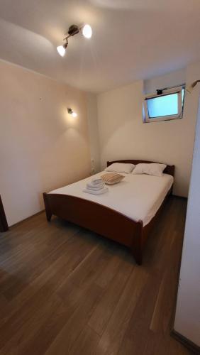 a bedroom with a large bed in a room at Apartman Sirius in Skradin