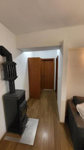 a living room with a stove and a couch at Apartman Sirius in Skradin