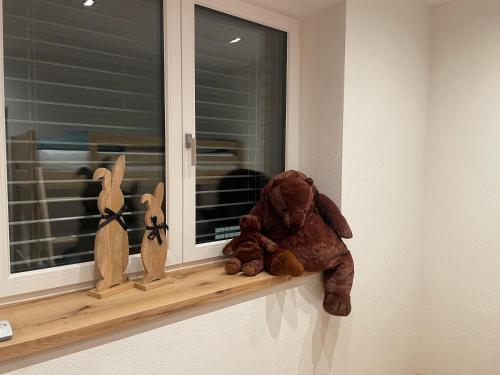 a stuffed teddy bear sitting on a window sill at Apart Christine in Brixlegg