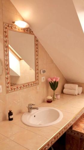 a bathroom with a sink and a mirror at Entire 2nd floor of Villa with 3bedroom with large garden,BBQ,pool,sauna,free parking in Popovičky