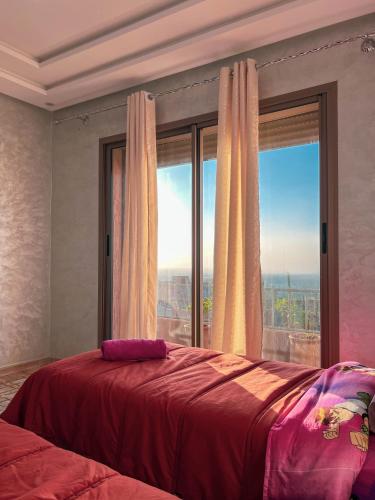 a bedroom with a bed with a large window at Ourika Luxury Villa in Ourika