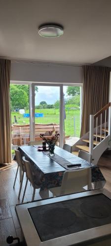 a living room with a dining room table and a couch at Agroturystyka Błądkowo 20A, Dom 11 miejsc in Błądkowo