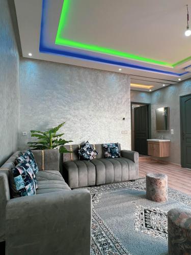 a living room with a couch and a green ceiling at Ourika Luxury Villa in Ourika