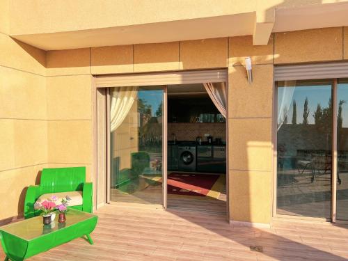 a building with a glass door with a table and a camera at Ourika Luxury Villa in Ourika