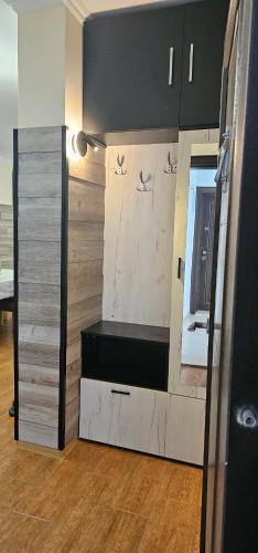 a room with a wall with a bench and a mirror at Amara Butik on the first line in Ravda