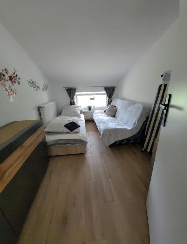 a room with two beds and a couch in it at Agroturystyka Błądkowo 20A, Dom 11 miejsc in Błądkowo