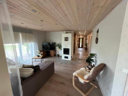 a living room with a couch and a wooden ceiling at Õuna 